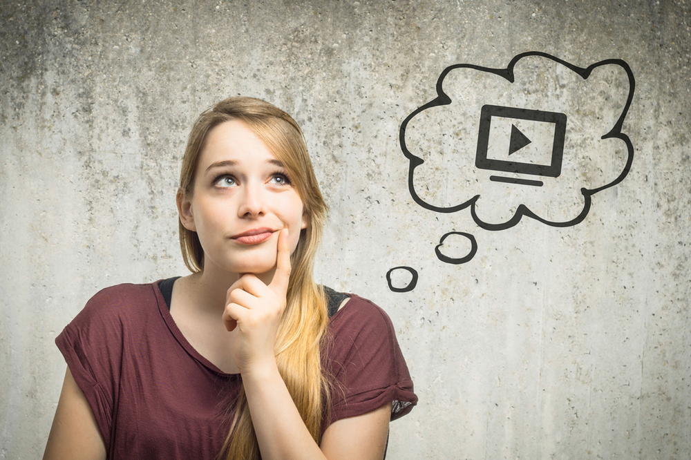 Woman thinking with a thought bubble showing a video player