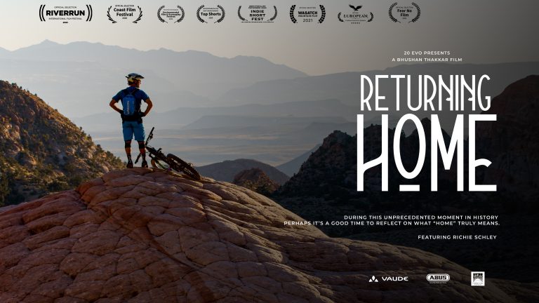 returning home poster with accolades, mountain biker looking out on a mountain vista with text that states, 20 evo presents, a bhushan thakkar film, returning home, more text states, during this unprecedented moment in history its a good time to reflect on what home truly means. Featuring richie schley