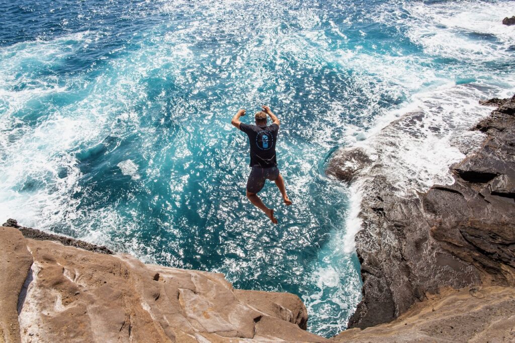 Pro surfer Anthony Walsh cliff jumping into the Pacific Ocean in Oahu, Hawaii during 20EVO short film production.